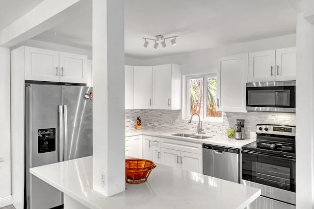 kitchen featuring sink, white cabinets, and appliances with stainless steel finishes