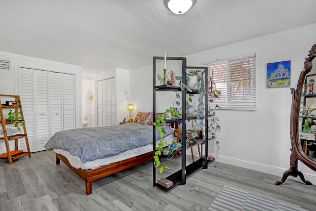 bedroom featuring ensuite bathroom and light hardwood / wood-style flooring