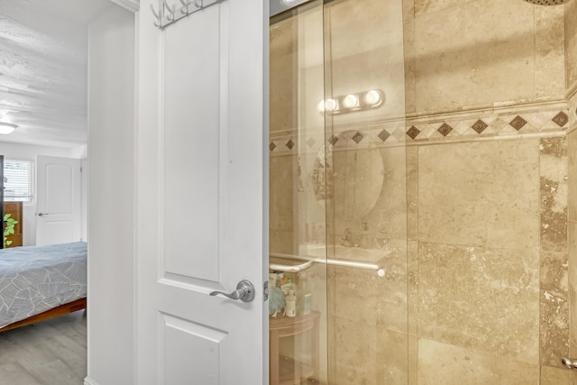 bathroom with wood-type flooring and a shower with door