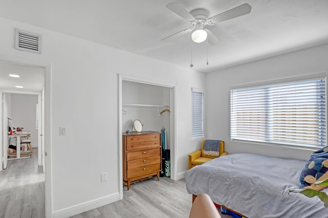 bedroom featuring ceiling fan, a closet, and light hardwood / wood-style flooring