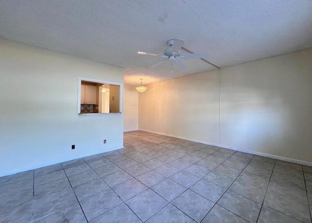 empty room featuring a textured ceiling and ceiling fan