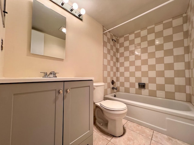 full bathroom featuring tiled shower / bath, tile patterned floors, toilet, and vanity