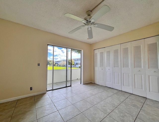 unfurnished bedroom with light tile patterned floors, access to exterior, ceiling fan, a textured ceiling, and a closet