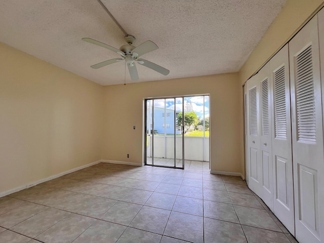 unfurnished bedroom featuring light tile patterned floors, access to exterior, ceiling fan, a textured ceiling, and a closet