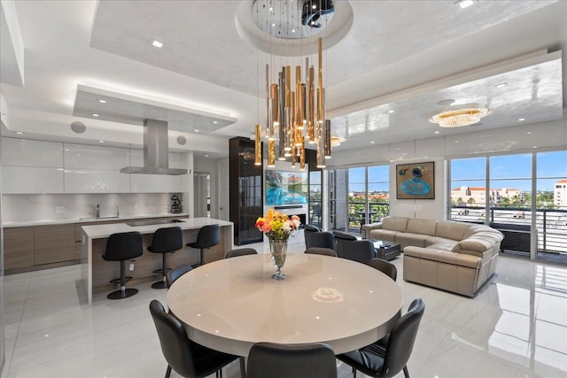 dining area featuring plenty of natural light and a raised ceiling