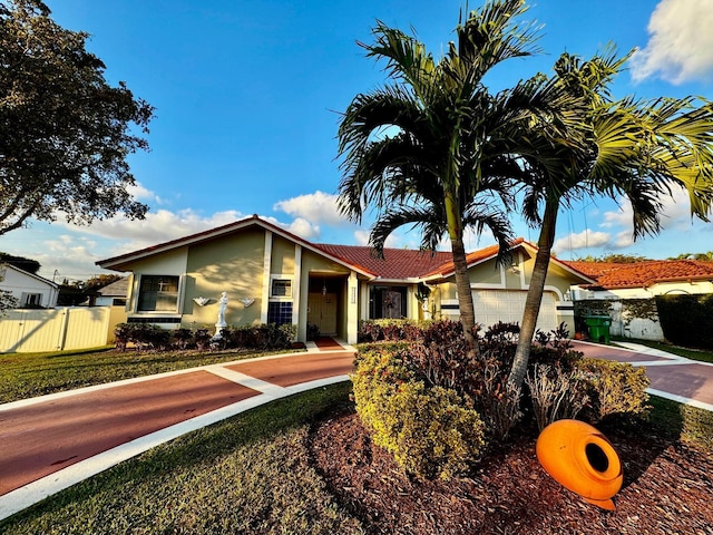 view of front of home featuring a garage and a front yard