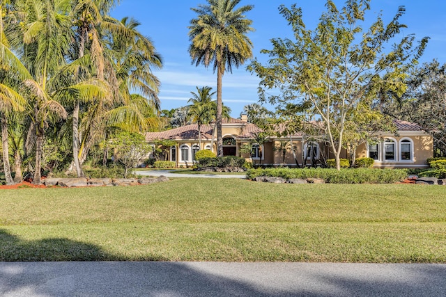 mediterranean / spanish home featuring a front yard