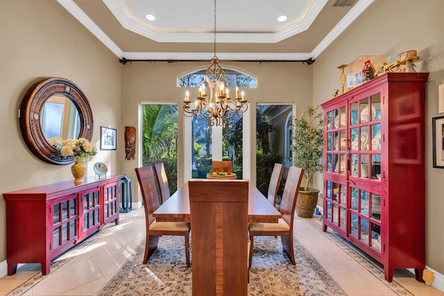 dining room with a chandelier, ornamental molding, a raised ceiling, and light tile patterned floors