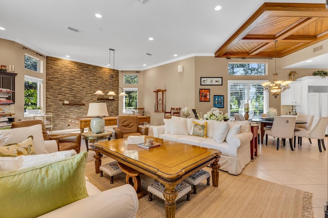 living room with light tile patterned floors, a notable chandelier, and ornamental molding