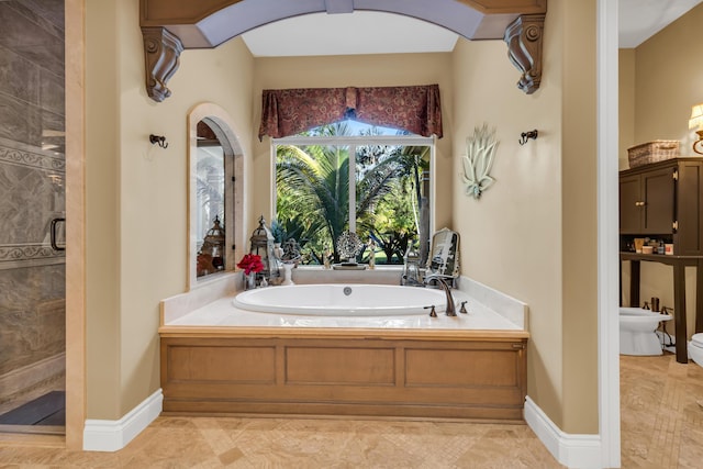 bathroom featuring a bidet and independent shower and bath