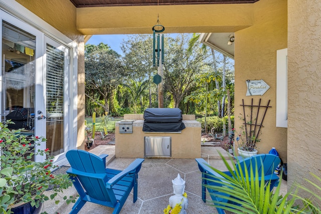 view of patio with area for grilling and exterior kitchen