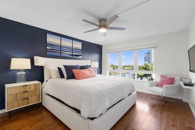 bedroom with ceiling fan and dark hardwood / wood-style floors