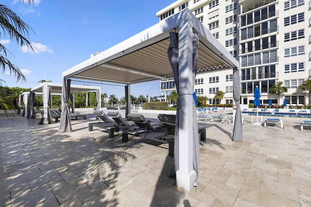 view of patio / terrace with a community pool and a gazebo