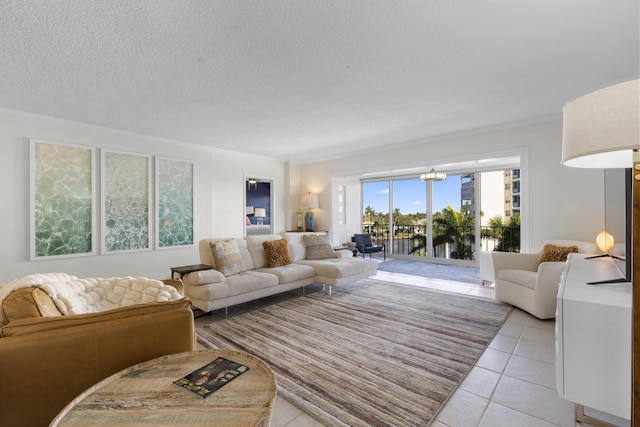 living area with a notable chandelier, light tile patterned flooring, a textured ceiling, and a water view