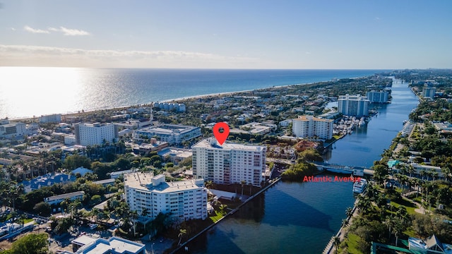 birds eye view of property with a water view and a view of city