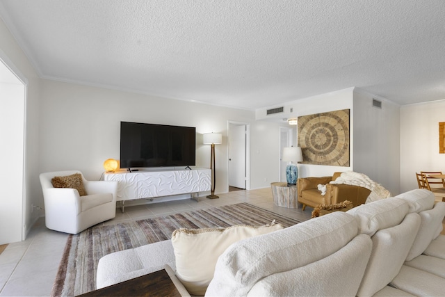 living area with a textured ceiling, tile patterned flooring, and visible vents