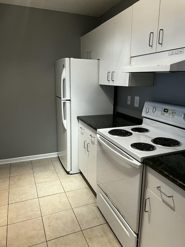 kitchen with electric stove, light tile patterned floors, white cabinetry, dark stone countertops, and a textured ceiling