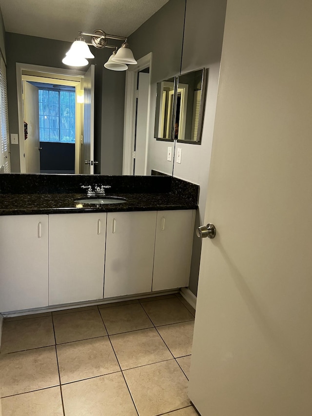 bathroom with tile patterned floors and vanity