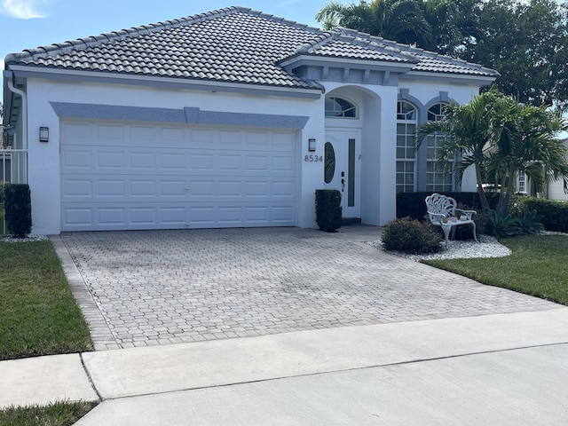 mediterranean / spanish-style home with a garage