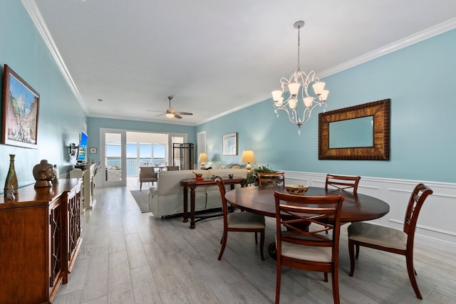 dining space featuring ceiling fan with notable chandelier, light hardwood / wood-style flooring, and ornamental molding