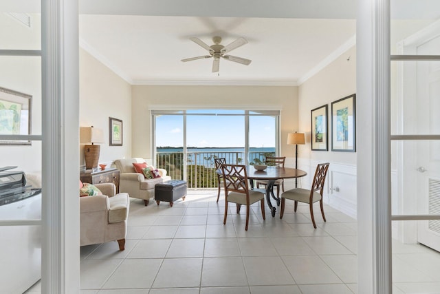 tiled dining room featuring ceiling fan and ornamental molding