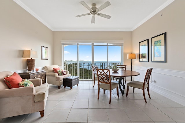 dining room with ornamental molding, a water view, light tile patterned floors, and ceiling fan