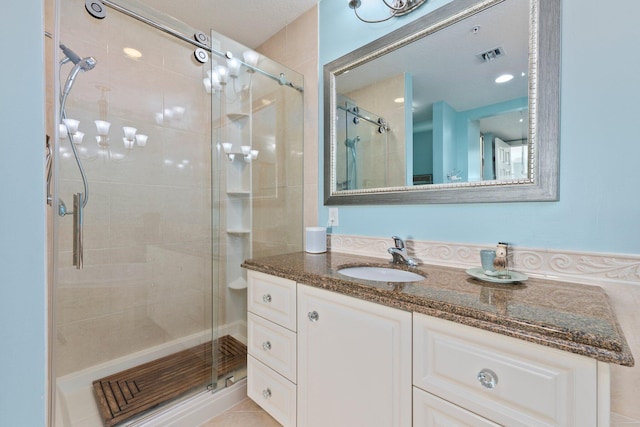 bathroom featuring an enclosed shower and vanity