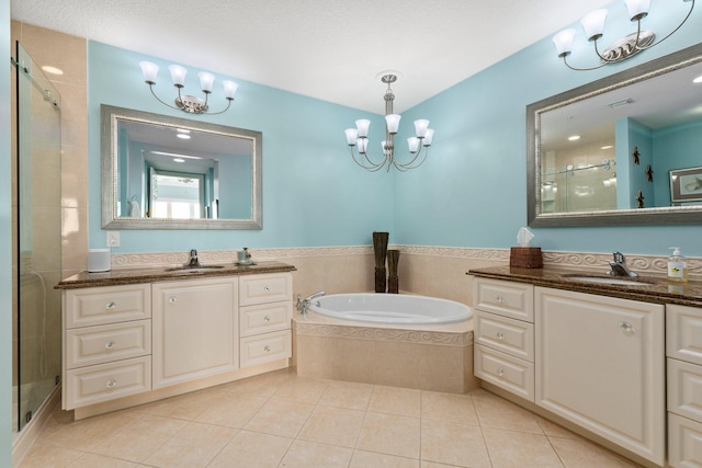 bathroom with plus walk in shower, tile patterned floors, a chandelier, and vanity