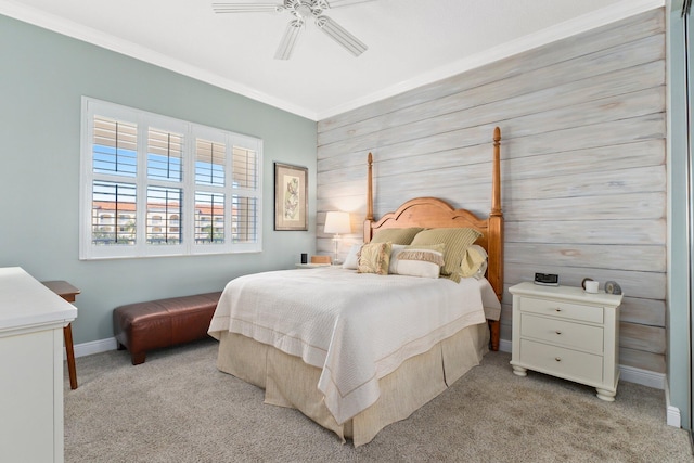 carpeted bedroom featuring crown molding, ceiling fan, and wood walls