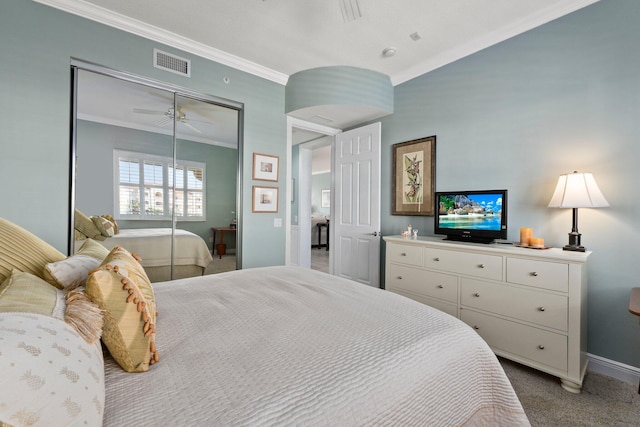 bedroom featuring crown molding, light carpet, and a closet