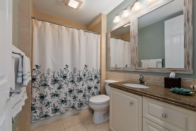 bathroom with tile patterned flooring, vanity, a shower with shower curtain, and toilet