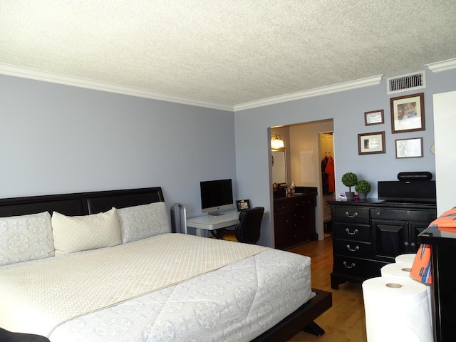 bedroom featuring ornamental molding, dark hardwood / wood-style flooring, and a textured ceiling