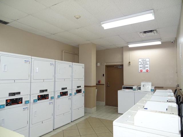 laundry room featuring stacked washer and clothes dryer, washer and clothes dryer, and light tile patterned floors