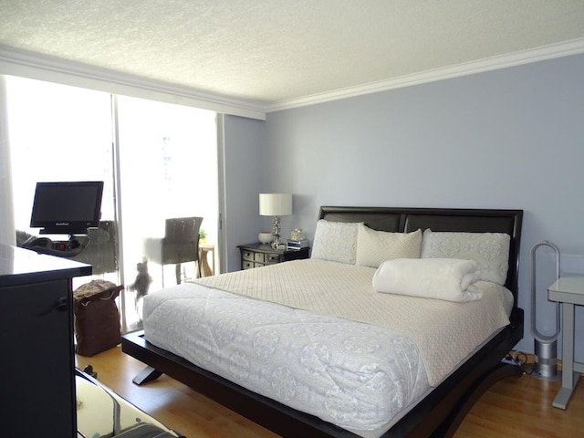 bedroom with wood-type flooring, floor to ceiling windows, a textured ceiling, and crown molding