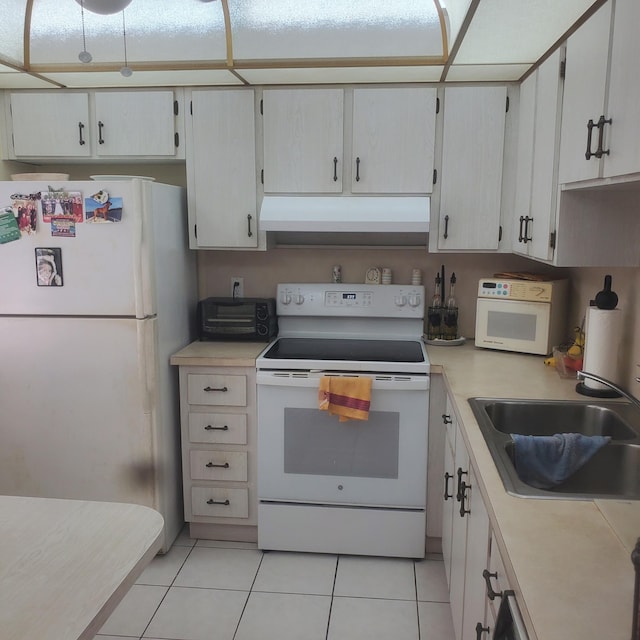 kitchen featuring light tile patterned flooring, white appliances, sink, and white cabinets