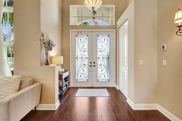 entrance foyer featuring french doors and dark hardwood / wood-style flooring