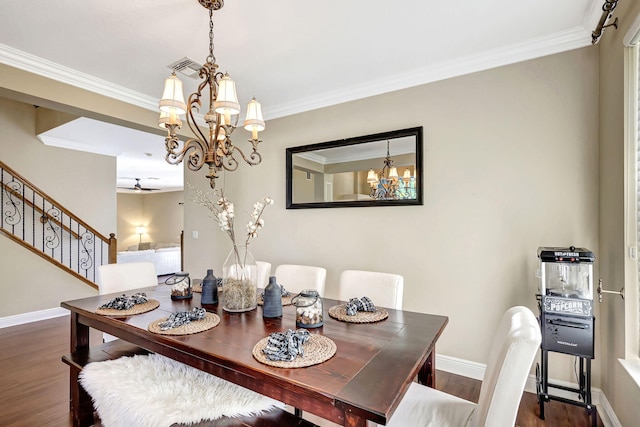 dining area featuring ornamental molding, dark hardwood / wood-style floors, and a chandelier