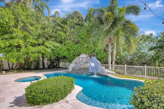 view of swimming pool featuring an in ground hot tub