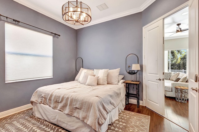 bedroom with crown molding, dark hardwood / wood-style flooring, and a notable chandelier