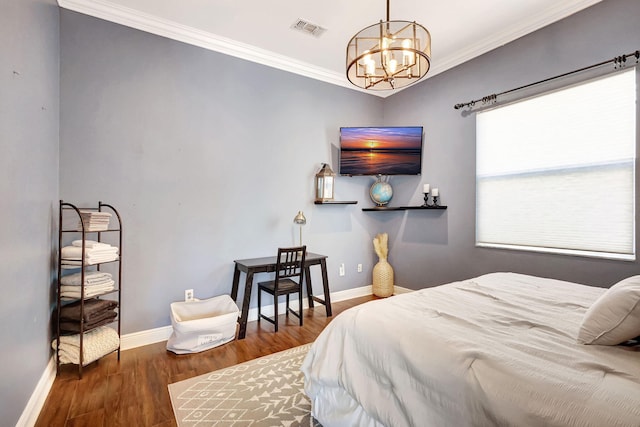 bedroom featuring crown molding, dark hardwood / wood-style floors, and a chandelier