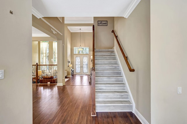 stairway featuring crown molding, hardwood / wood-style floors, and french doors