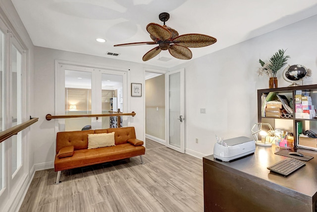 office space featuring ceiling fan and light hardwood / wood-style flooring