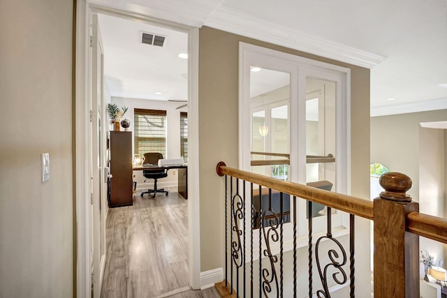 hallway featuring ornamental molding and wood-type flooring