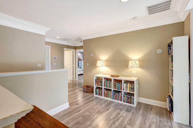 hall with crown molding and light wood-type flooring