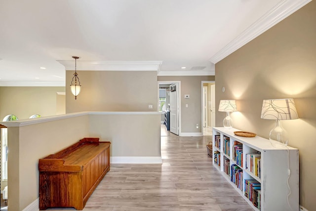 corridor featuring ornamental molding and light hardwood / wood-style flooring