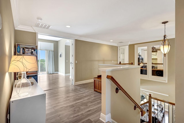 hall featuring crown molding and light hardwood / wood-style floors