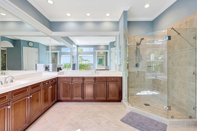 bathroom featuring vanity, tile patterned flooring, a shower with shower door, and ornamental molding