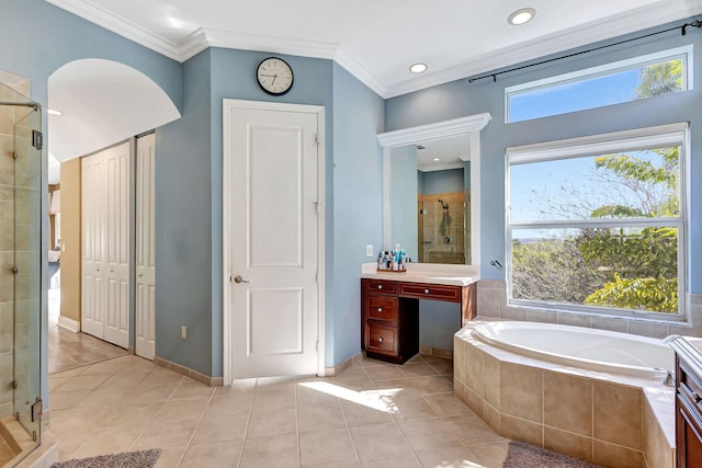 bathroom with ornamental molding, shower with separate bathtub, and a wealth of natural light