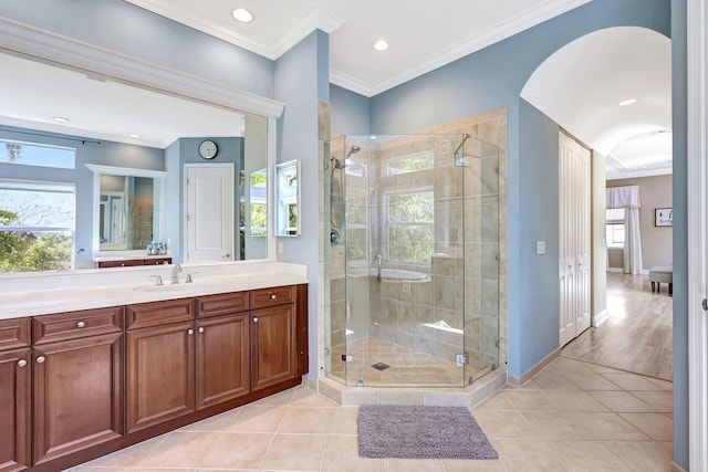 bathroom with tile patterned flooring, ornamental molding, and an enclosed shower