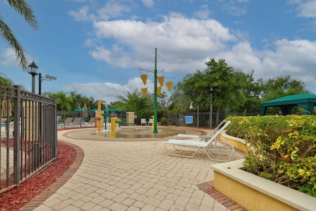 view of home's community with a patio and a playground